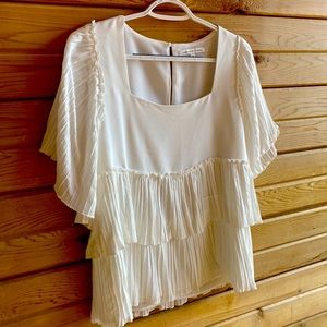 Cute white ruffle short sleeved top. Goes with so many things. Never been worn.